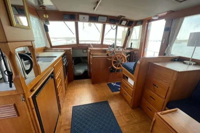 Slide: The Image of Interior of 1987 Grand Banks 42 Classic Trawler, featuring wood cabinetry and helm station. - 10