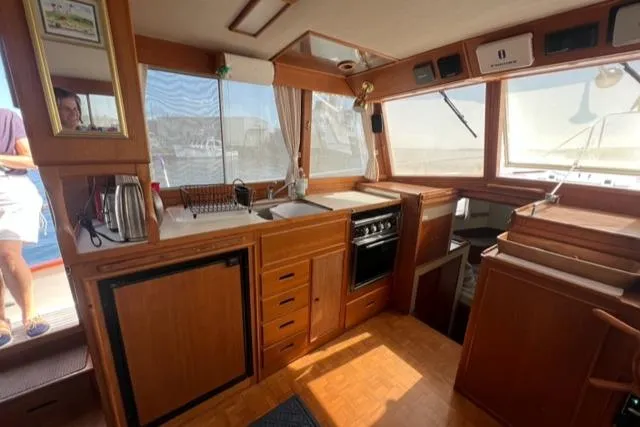 Slide: The Image of 1987 Grand Banks 42 Classic Trawler interior with wood cabinetry and kitchen appliances. - 13