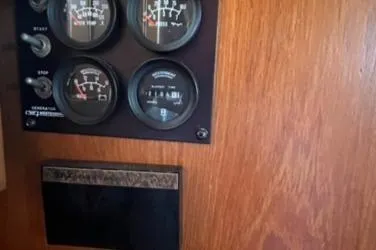 Slide: The Image of Control panel of 1987 Grand Banks 42 Classic Trawler, featuring gauges and switches. - 15