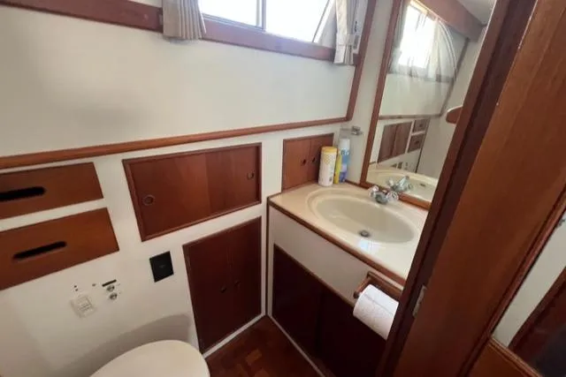 Slide: The Image of 1987 Grand Banks 42 Classic Trawler bathroom with wood cabinetry and sink. - 17