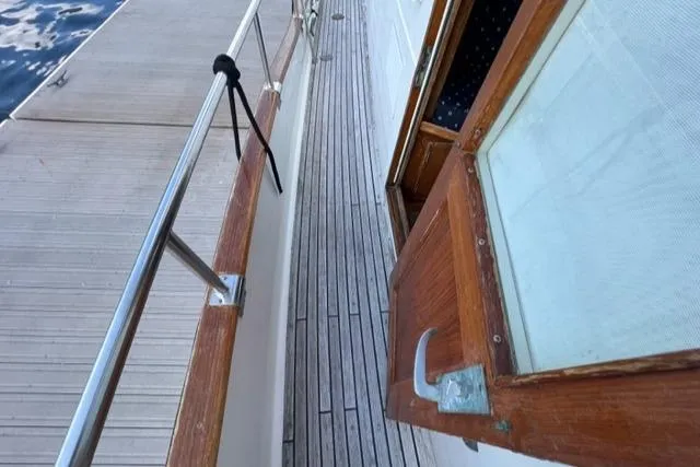 Slide: The Image of 1987 Grand Banks 42 Classic Trawler deck with wooden door and railing. - 28