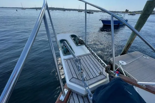 Slide: The Image of Bow of 1987 Grand Banks 42 Classic Trawler at dock, with visible anchor chain. - 30