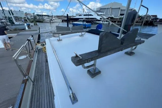 Slide: The Image of 1987 Grand Banks 42 Classic Trawler docked at marina, showcasing deck and railings. - 34