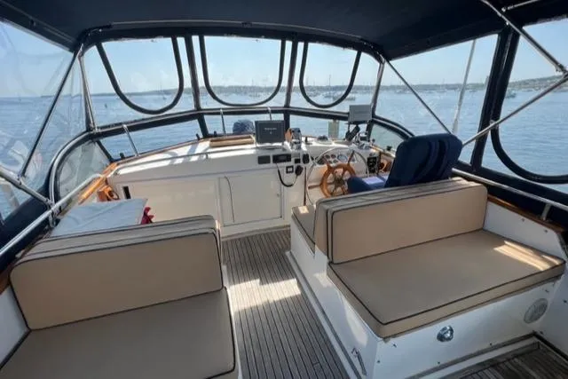 Slide: The Image of 1987 Grand Banks 42 Classic Trawler helm with seating, steering wheel, and navigation equipment. - 37