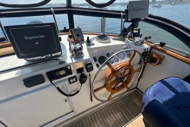 Slide: The Image of 1987 Grand Banks 42 Classic Trawler helm with navigation equipment and wooden steering wheel. - 39