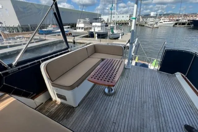 Slide: The Image of 1987 Grand Banks 42 Classic Trawler deck with seating and table, docked at marina. - 40