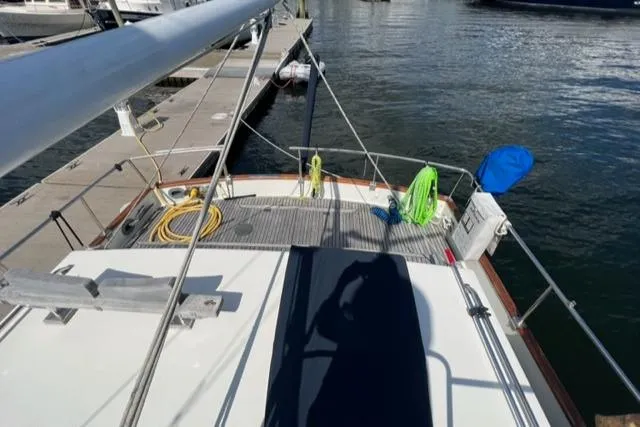 Slide: The Image of 1987 Grand Banks 42 Classic Trawler docked, showing deck and marina view. - 43