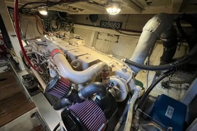 Slide: The Image of Engine room of 1987 Grand Banks 42 Classic Trawler, showcasing mechanical components and piping. - 45