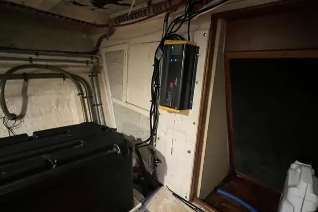 Slide: The Image of Engine room of 1987 Grand Banks 42 Classic Trawler, featuring electrical components and wiring. - 47