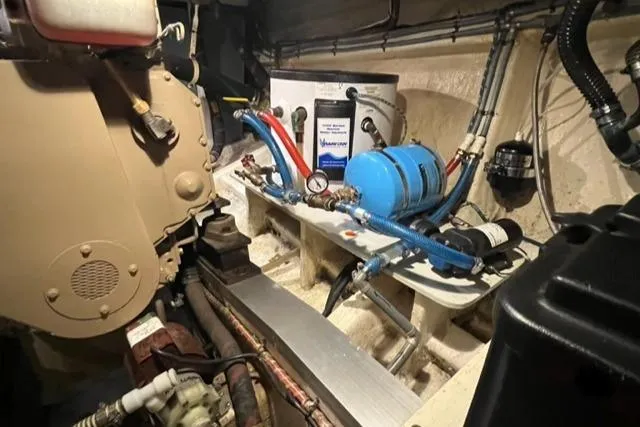 Slide: The Image of Engine room of 1987 Grand Banks 42 Classic Trawler, featuring mechanical components and piping. - 48