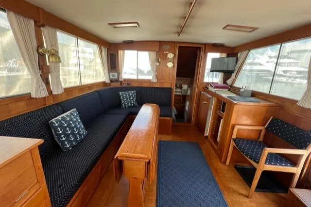 Slide: The Image of Interior of 1987 Grand Banks 42 Classic Trawler with wood furnishings and navy seating. - 5