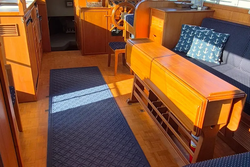 Slide: The Image of Interior of 1987 Grand Banks 42 Classic Trawler, featuring wood finish and nautical decor. - 7