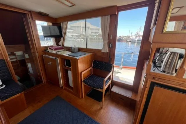 Slide: The Image of Interior of 1987 Grand Banks 42 Classic Trawler, featuring wood paneling and waterfront view. - 9