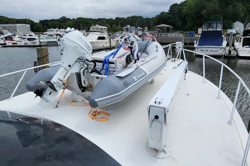 Slide: The Image of 2001 Ocean Yachts 56 Super Sport with dinghy on deck, docked at marina. - 13