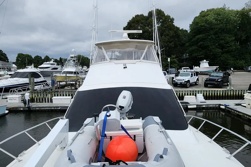 Slide: The Image of 2001 Ocean Yachts 56 Super Sport docked with inflatable boat on deck. - 14