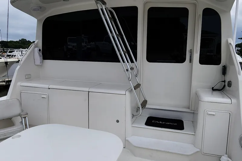Slide: The Image of 2001 Ocean Yachts 56 Super Sport yacht deck with seating and ladder. - 18