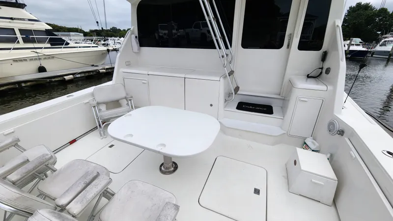 Slide: The Image of 2001 Ocean Yachts 56 Super Sport boat deck with seating and table, docked at marina. - 19