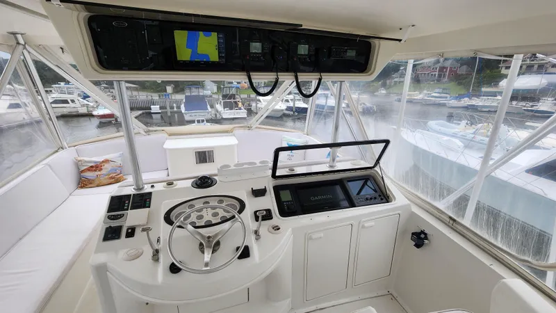 Slide: The Image of Cockpit of 2001 Ocean Yachts 56 Super Sport with navigation equipment and steering wheel. - 31