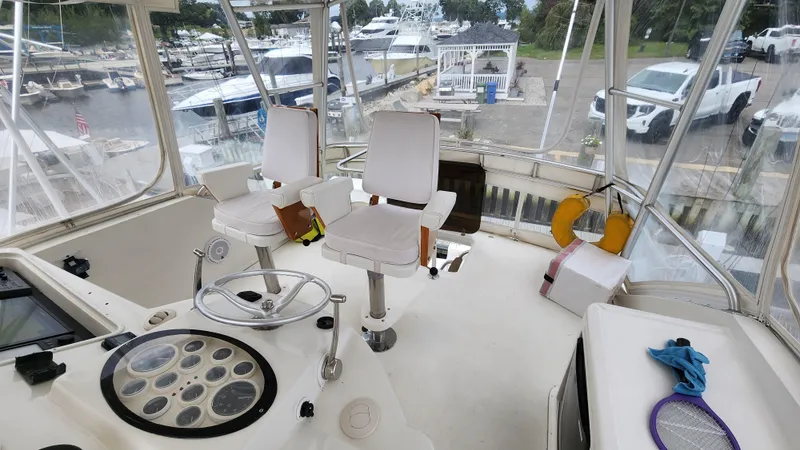 Slide: The Image of 2001 Ocean Yachts 56 Super Sport cockpit with helm chairs and marina view. - 36