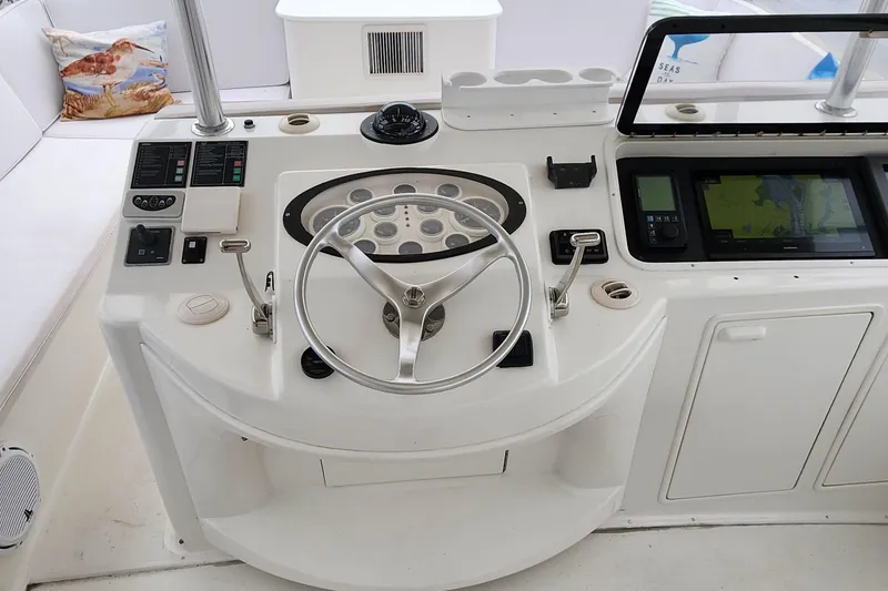 Slide: The Image of 2001 Ocean Yachts 56 Super Sport helm with steering wheel and navigation controls. - 37