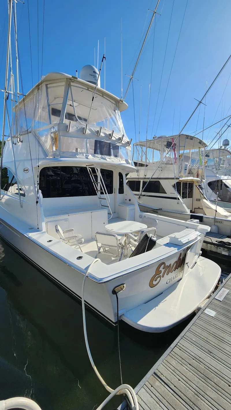 Slide: The Image of 2001 Ocean Yachts 56 Super Sport docked at marina under clear blue sky. - 4