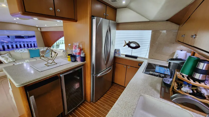 Slide: The Image of Luxurious kitchen interior of 2001 Ocean Yachts 56 Super Sport with modern appliances. - 48