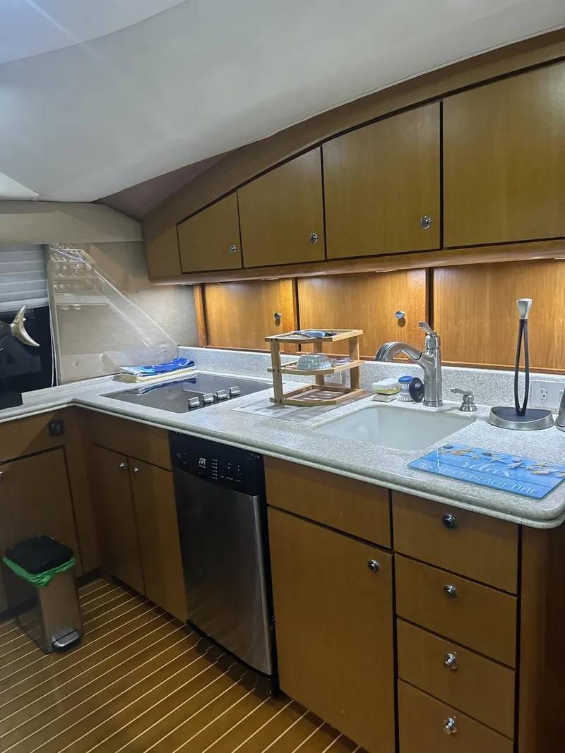 Slide: The Image of 2001 Ocean Yachts 56 Super Sport kitchen with wooden cabinets and modern appliances. - 49
