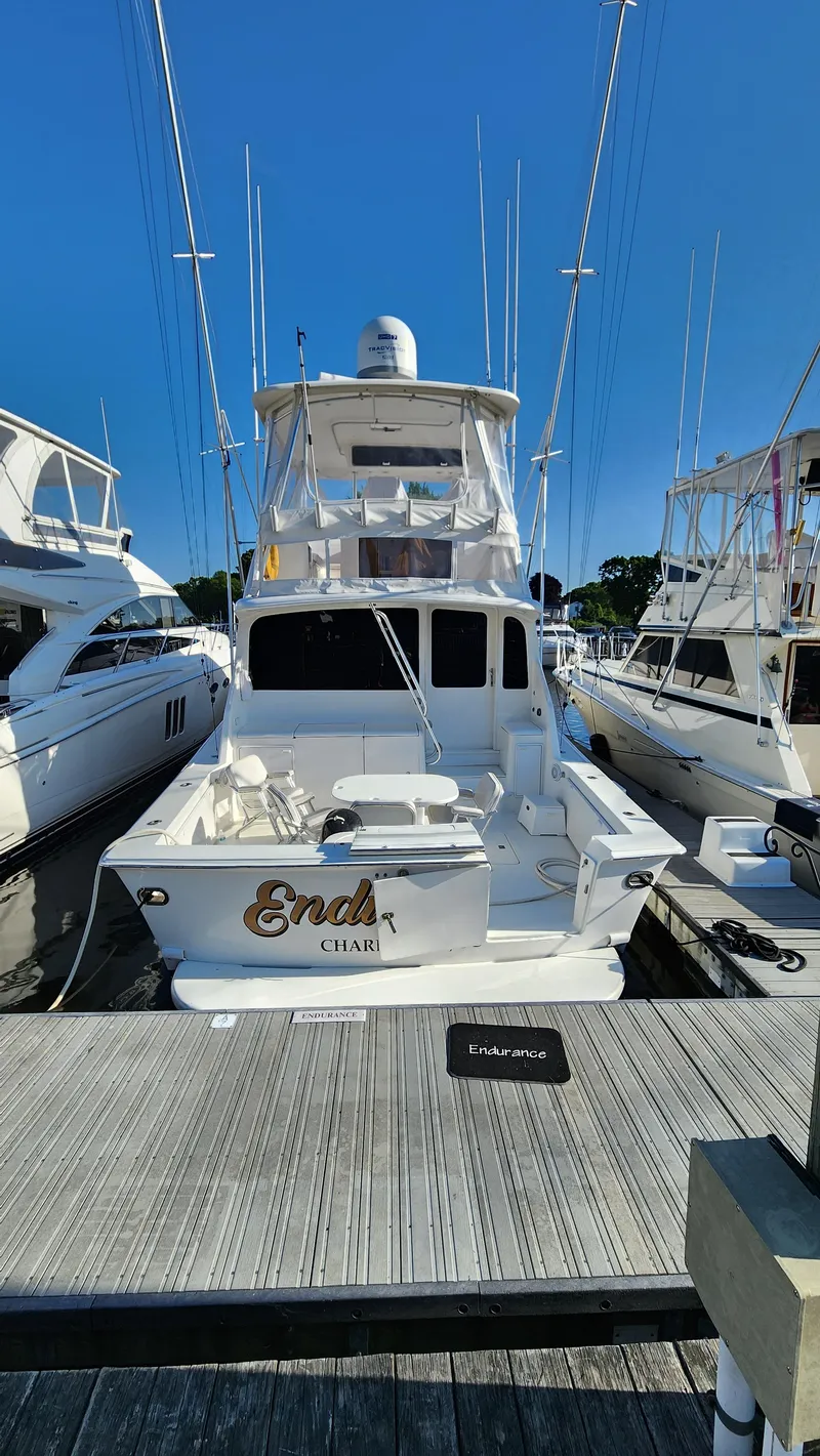 Slide: The Image of 2001 Ocean Yachts 56 Super Sport docked, rear view with clear blue sky. - 7