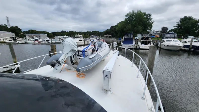 Slide: The Image of 2001 Ocean Yachts 56 Super Sport docked with inflatable boat on deck. - 10