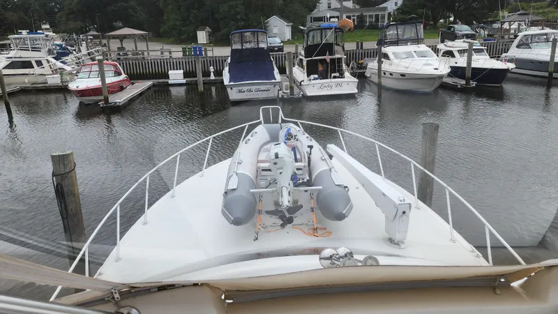 Slide: The Image of 2001 Ocean Yachts 56 Super Sport docked with inflatable boat on deck. - 11