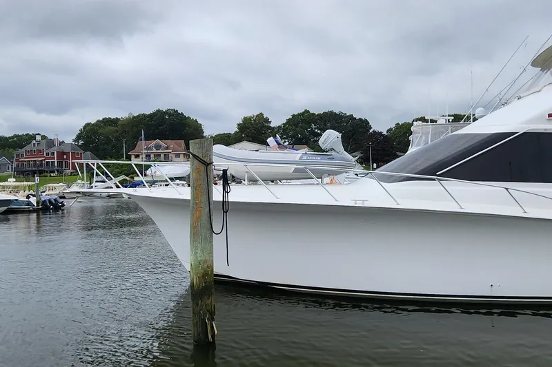 Slide: The Image of 2001 Ocean Yachts 56 Super Sport docked in a marina with overcast skies. - 15