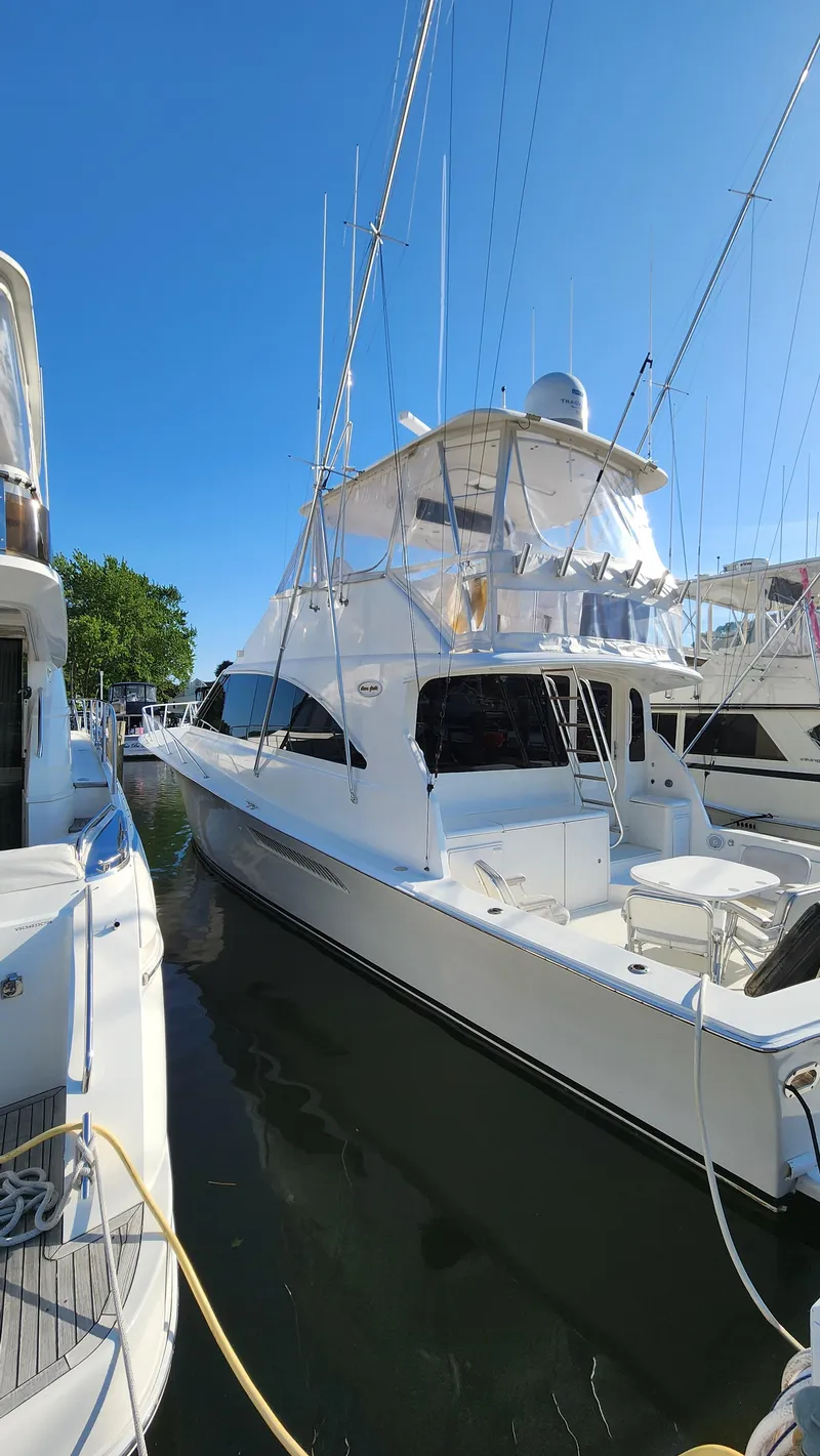 Slide: The Image of 2001 Ocean Yachts 56 Super Sport docked under clear blue sky. - 2