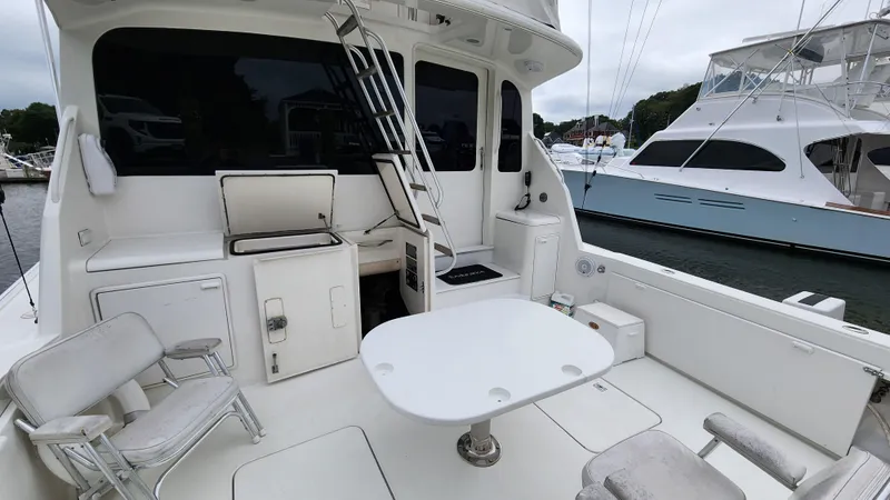 Slide: The Image of 2001 Ocean Yachts 56 Super Sport yacht deck with seating and table, docked at marina. - 20