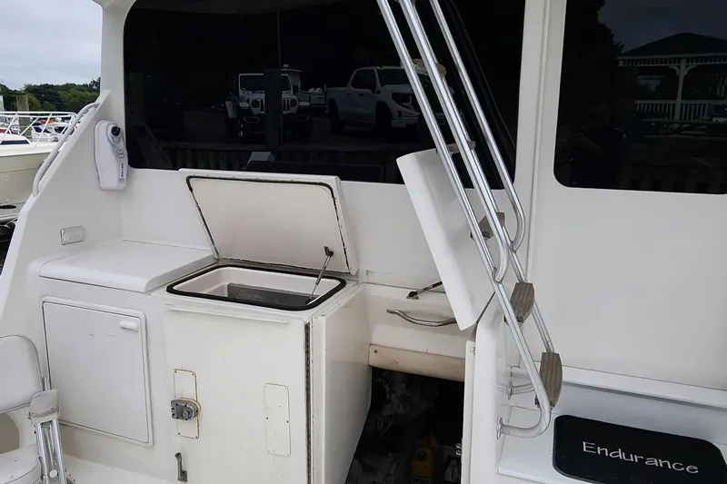 Slide: The Image of 2001 Ocean Yachts 56 Super Sport boat deck with storage compartments and ladder. - 22