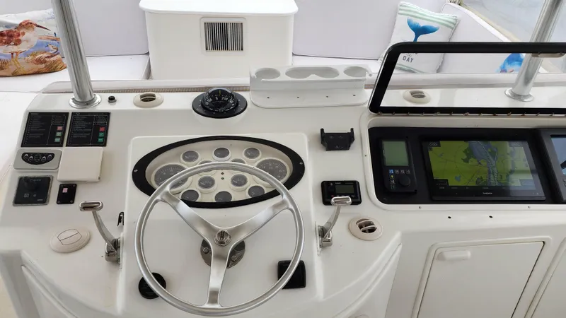 Slide: The Image of Cockpit of 2001 Ocean Yachts 56 Super Sport with steering wheel and navigation equipment. - 30