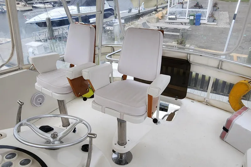 Slide: The Image of 2001 Ocean Yachts 56 Super Sport helm with dual captain chairs and steering wheel. - 38