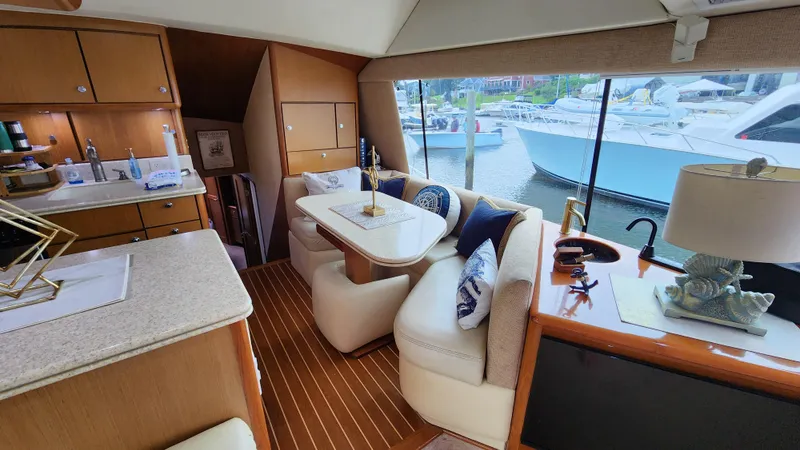 Slide: The Image of Interior of 2001 Ocean Yachts 56 Super Sport with elegant seating and marina view. - 46