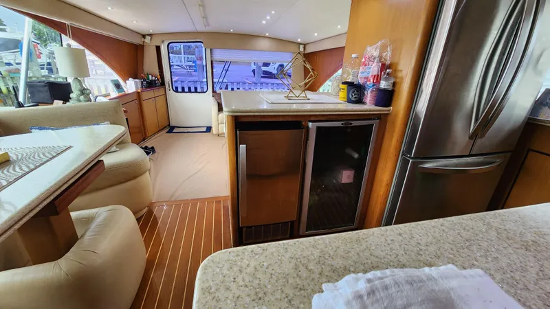 Slide: The Image of Interior of 2001 Ocean Yachts 56 Super Sport, featuring modern kitchen and seating area. - 47