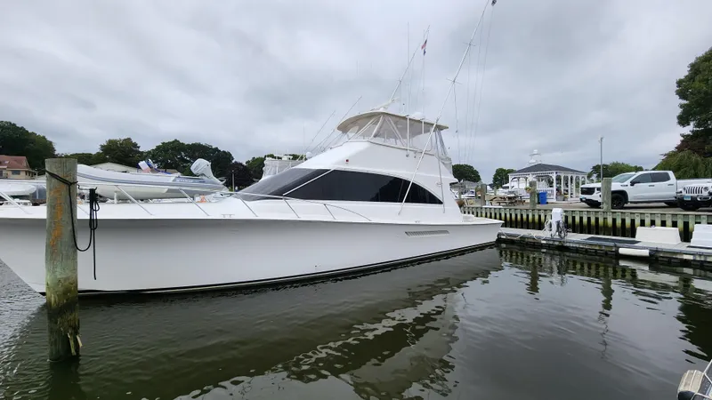 Slide: The Image of 2001 Ocean Yachts 56 Super Sport docked in a marina, overcast sky. - 9
