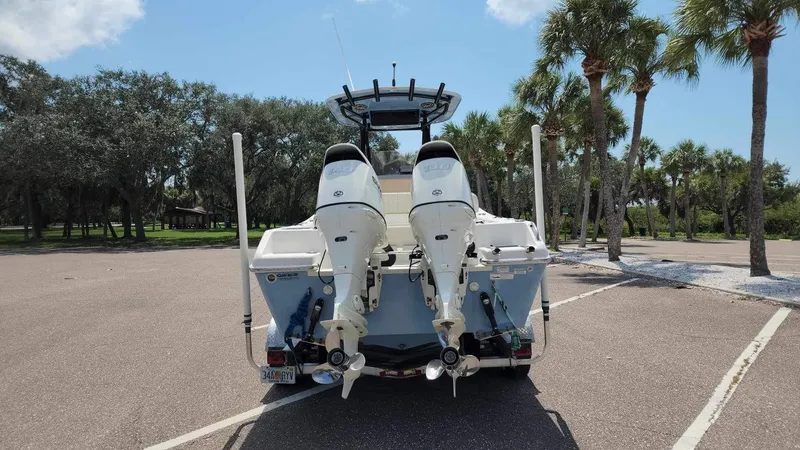 Slide: The Image of 2017 Sea Chaser 24 HFC boat with twin outboard engines in a parking lot. - 18
