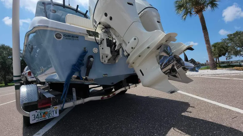 Slide: The Image of 2017 Sea Chaser 24 HFC boat on trailer with outboard motor in parking lot. - 19
