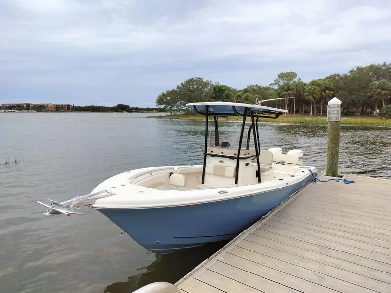Slide: The Image of 2017 Sea Chaser 24 HFC boat docked on a calm lake. - 2