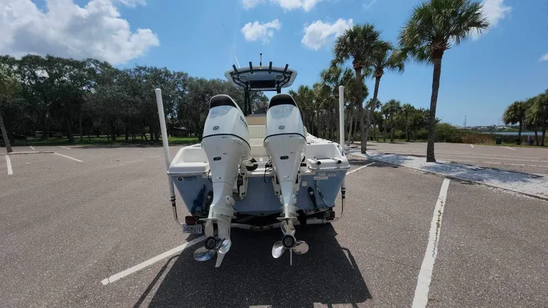 Slide: The Image of 2017 Sea Chaser 24 HFC boat with twin outboard motors in a parking lot. - 21