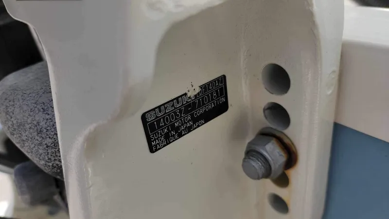 Slide: The Image of Close-up of a 2017 Sea Chaser 24 HFC boat's Suzuki engine serial number plate. - 25
