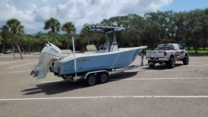 Slide: The Image of 2017 Sea Chaser 24 HFC boat on trailer, parked in a lot with a truck. - 28
