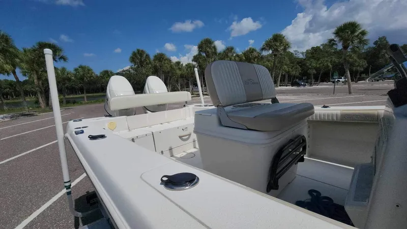 Slide: The Image of 2017 Sea Chaser 24 HFC boat interior with seating and storage, parked in a sunny lot. - 33