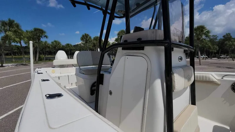 Slide: The Image of 2017 Sea Chaser 24 HFC boat interior with seating and console, parked outdoors. - 36