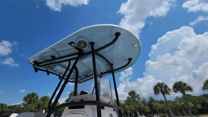 Slide: The Image of 2017 Sea Chaser 24 HFC boat under a clear blue sky with palm trees. - 37