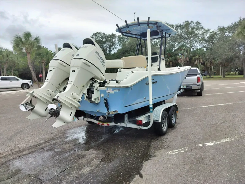 Slide: The Image of 2017 Sea Chaser 24 HFC boat on trailer with dual engines in parking lot. - 4
