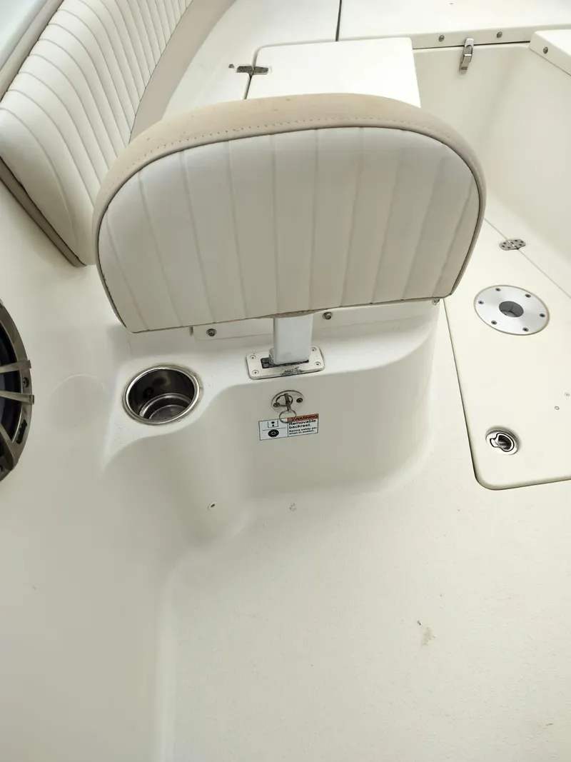 Slide: The Image of 2017 Sea Chaser 24 HFC boat interior with cushioned seating and cup holder. - 46
